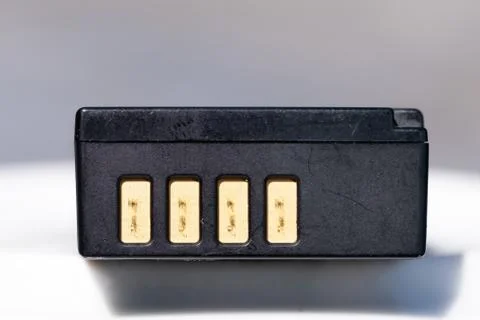 Battery for DSLR or system camera. Rechargeable on white with gray background Stock Photos