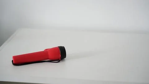 Battery powered flashlight on a white background. Copy space. Stock Photos