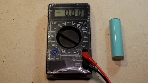 Battery voltage measurement with a multimeter Stock Footage 89435337