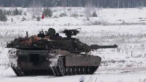 Battle tank turret rotating while stopped on snow covered ground Stock Footage 257060117