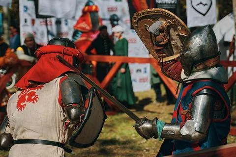 Battle of two knights from different historical clubs in the arena. Stock Photos