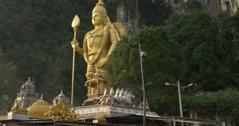 Batu caves statue from right side birds flying across Stock Footage 112848153