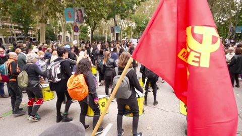 Batucada members from behind playing drums with red communist flag 스톡 동영상 254366911