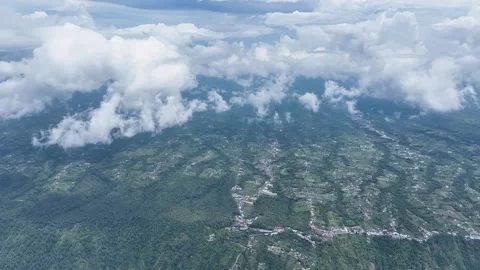 Batur Caldera emerald patchwork unfolds beneath drifting clouds. Endless Video stock 329569427