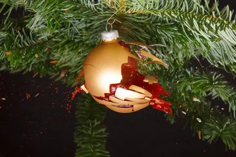 Bauble on a Christmas tree exploding. Concept for a ruined christmas Stock Photos