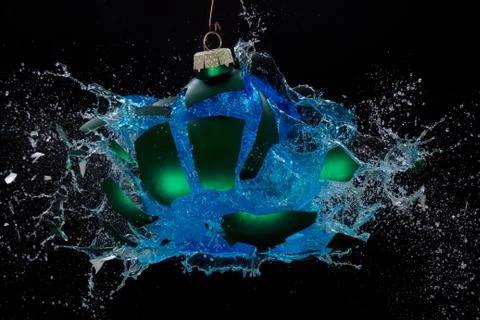 Bauble exploding, liquid splashing around Stock Photos