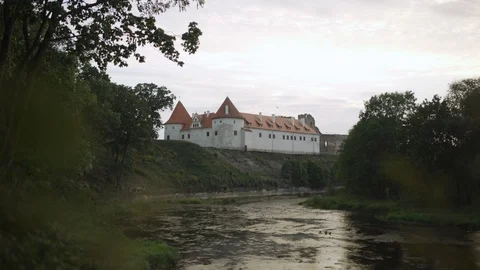 Bauska Castle by river at sunset Video stock 104046498