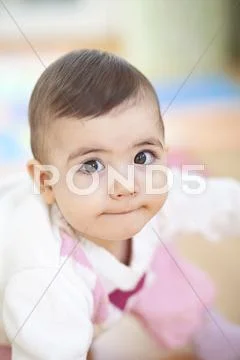 Bavaria, Baby girl crouching Stock Photos