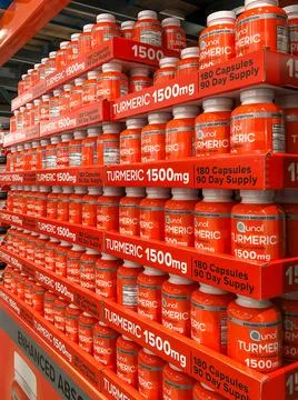 BAXTER, MN - 5 JAN 2022: Store display of Tumeric capsules in bottles. Stock Photos
