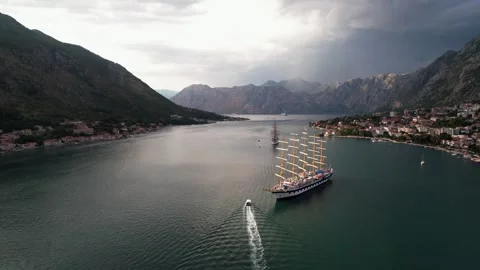 Bay is adorned with Sailing Ship gracefully navigating under Dramatic Skies Stock Footage 320746331