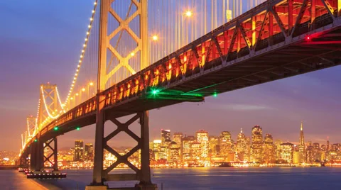 Bay Bridge and San Francisco skyline at night Stock Footage