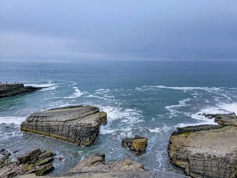 Bay with cliffs and rock islets and many waves Stock Photos