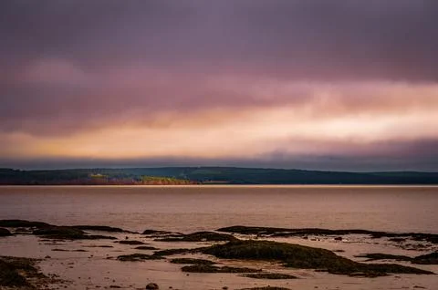 Bay of Fundy at low tide with dramatic colourful sky, New Brunswick, Canada Stock Photos