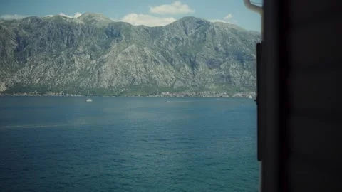 Bay of Kotor view with karst cliffs, sailboat, and motorboat, Montenegro Vidéo 329412975