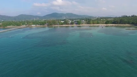 Bay with a pier, a tropical landscape, constructions ashore, shooting from air Stock-Footage 82072343