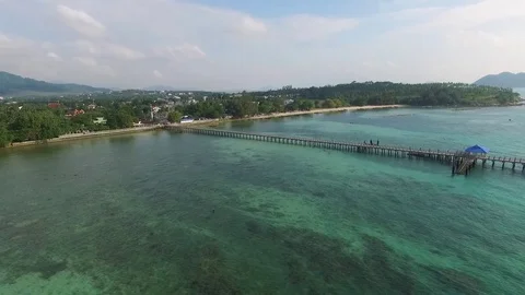 Bay with a pier, a tropical landscape, constructions ashore, shooting from air Stock-Footage 82072457