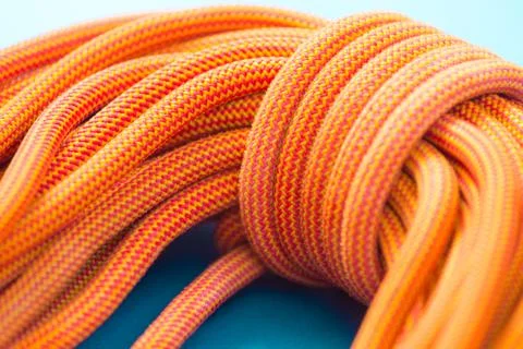 Bayed rope for climbing. Orange rope for mountaineering close up. Node Stock Photos
