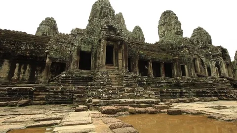 Bayon temple seen from outside, smooth tilt from floor to towers Stock Footage 76381676