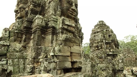 Bayon temple smooth tilt from railing to stone faces Stock Footage 76381789