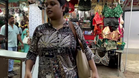 Bazaar scene in India with people walking and shopping at a street stall Vídeo Stock 336942720