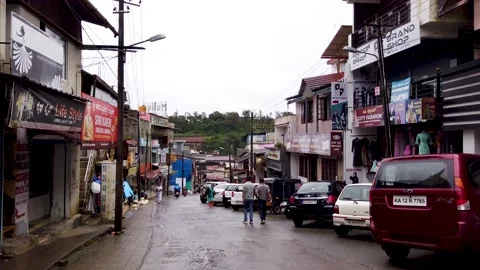 Bazaar street lined up with shops and automobiles in Coorg, India. Stock Footage 193261493