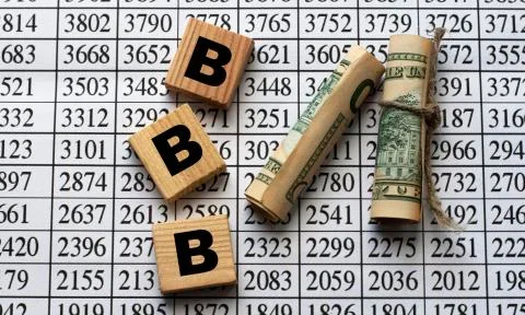 BBB - acronym on cubes on paper background with numbers and banknotes Stock Photos
