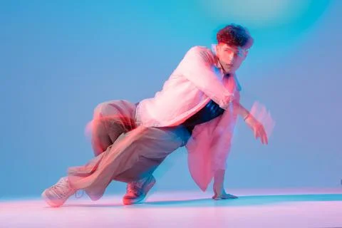 Bboy breakdance move with motion blur in neon studio Stock Photos