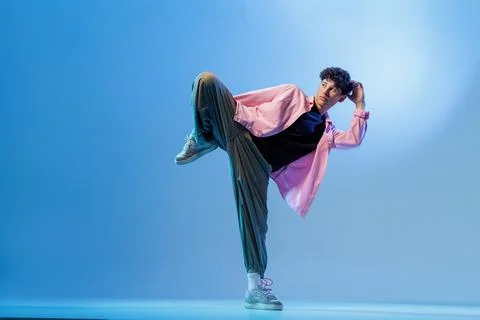 Bboy freeze in neon blue studio with copy space Stock Photos