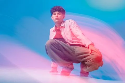 Bboy pose with neon motion trails in studio hip hop street dance portrait Stock Photos