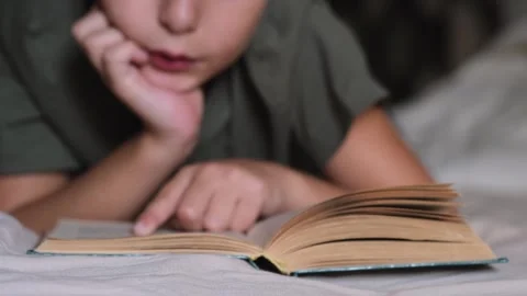 Bboy read a book in a bed. Video stock 252447355