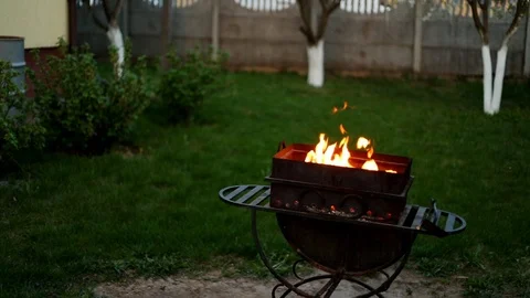 BBQ. Barbecue in the backyard in the late evening in the summer . Flames of fire Stock Footage 112949510