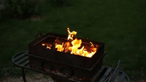 BBQ. Barbecue in the backyard in the late evening in the summer . Flames of fire Stock Footage 112949542