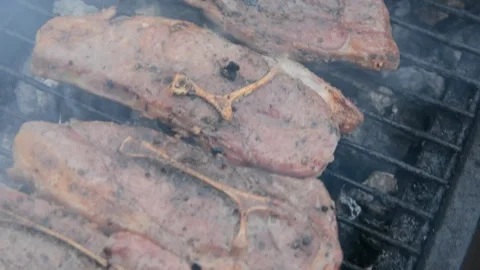 BBQ close up. Lamb shoulder steaaks on coals Video stock 130372814