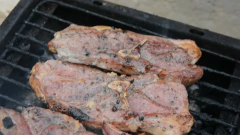 BBQ close up. Lamb shoulder steaaks on coals Stock Footage 130372819