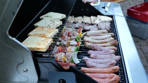 BBQ Close-up shot. Different types of steaks and sausages on a barbeque grill Video stock 225726904