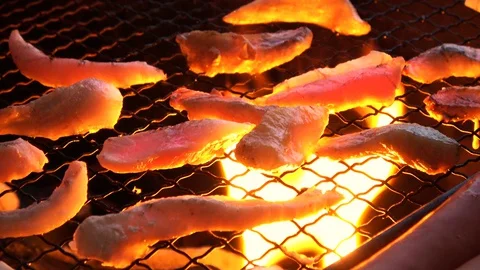 BBQ. Closeup shot of chicken being grilled by open fire. 4K Stock Footage 128221787
