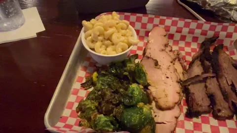 BBQ dinner with macaroni and cheese, Brussel sprouts, sliced turkey and sliced Stock Footage 305252637