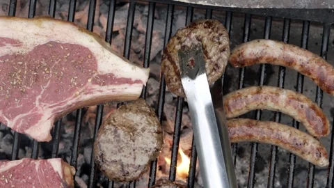 BBQ - flipping meat - summer Stock Footage 91525455