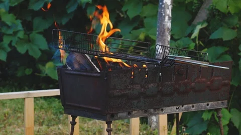 Bbq grill flame, hot burning grill, outdoors 4k Stock Footage 117223765