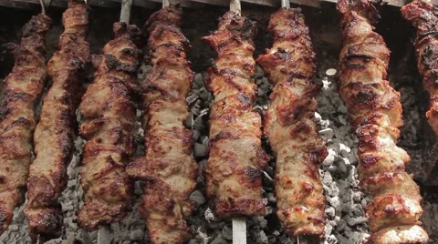 BBQ grilled meat cooked on a skewer. Grilling food at an outdoor picnic Stock Footage 40974579