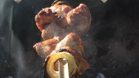 BBQ meat is being cooked on the open fire Stock Footage 133228365