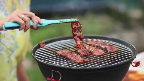 BBQ Party Scene - Sizzling Beef Steaks on Hot Grill Outdoors. Stock Footage 336536646