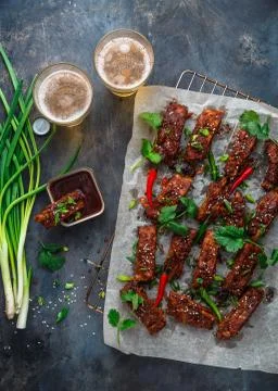 BBQ Ribs with beer, onion and chili. Stock Photos