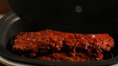 BBQ ribs steaming hot. In pressure cooker cu B Stock Footage 106827775