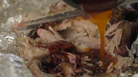 BBQ sauce poured on tender pulled pork Stock Footage 244689221