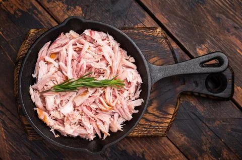 BBQ smoked Pulled Chicken meat in a skillet. wooden background. top view Stock Photos