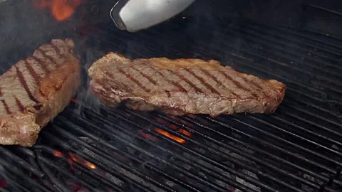 BBQ steak on grill. Grilling on fire meat. Stock Footage 155774786