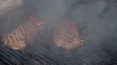 BBQ steak on grill. Grilling on fire meat. Grilling on fire meat Stock Footage 155774793