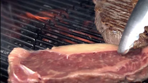 BBQ steak on grill. Grilling on fire meat Stock Footage 155774825