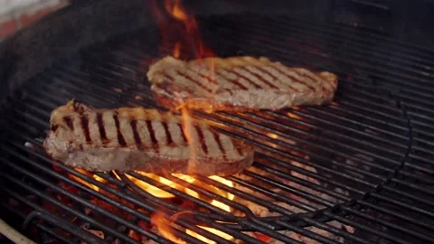 BBQ steak on grill. Grilling on fire meat Stock Footage 155774828